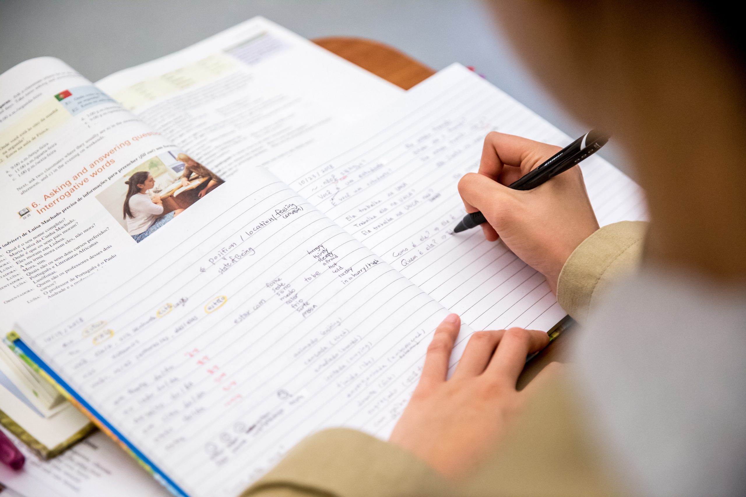 Student writing on notebook paper